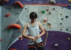 focused ethnic female climber preparing for climbing training